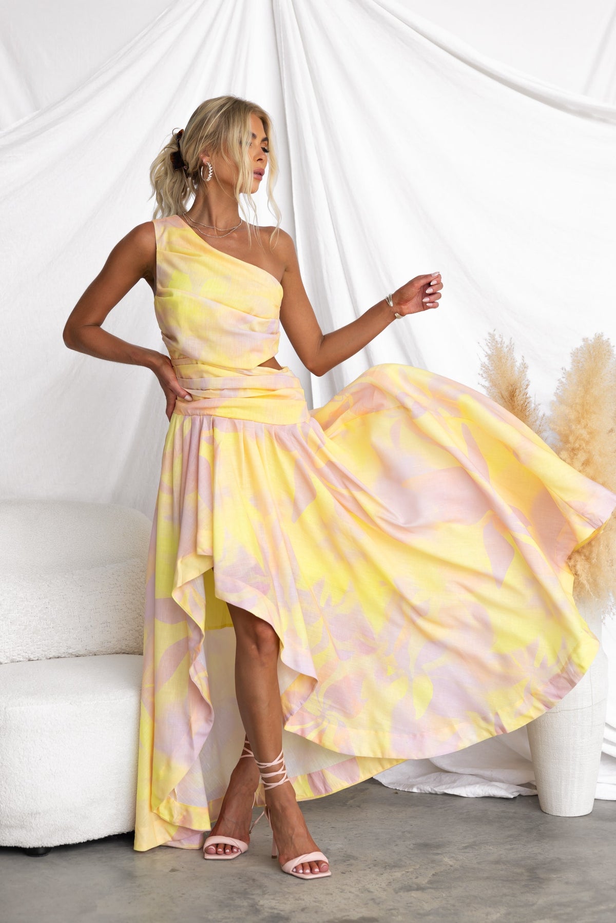 Model wearing a multi-colour Horizons Maxi Dress with a one-shoulder neckline and asymmetrical hemline.