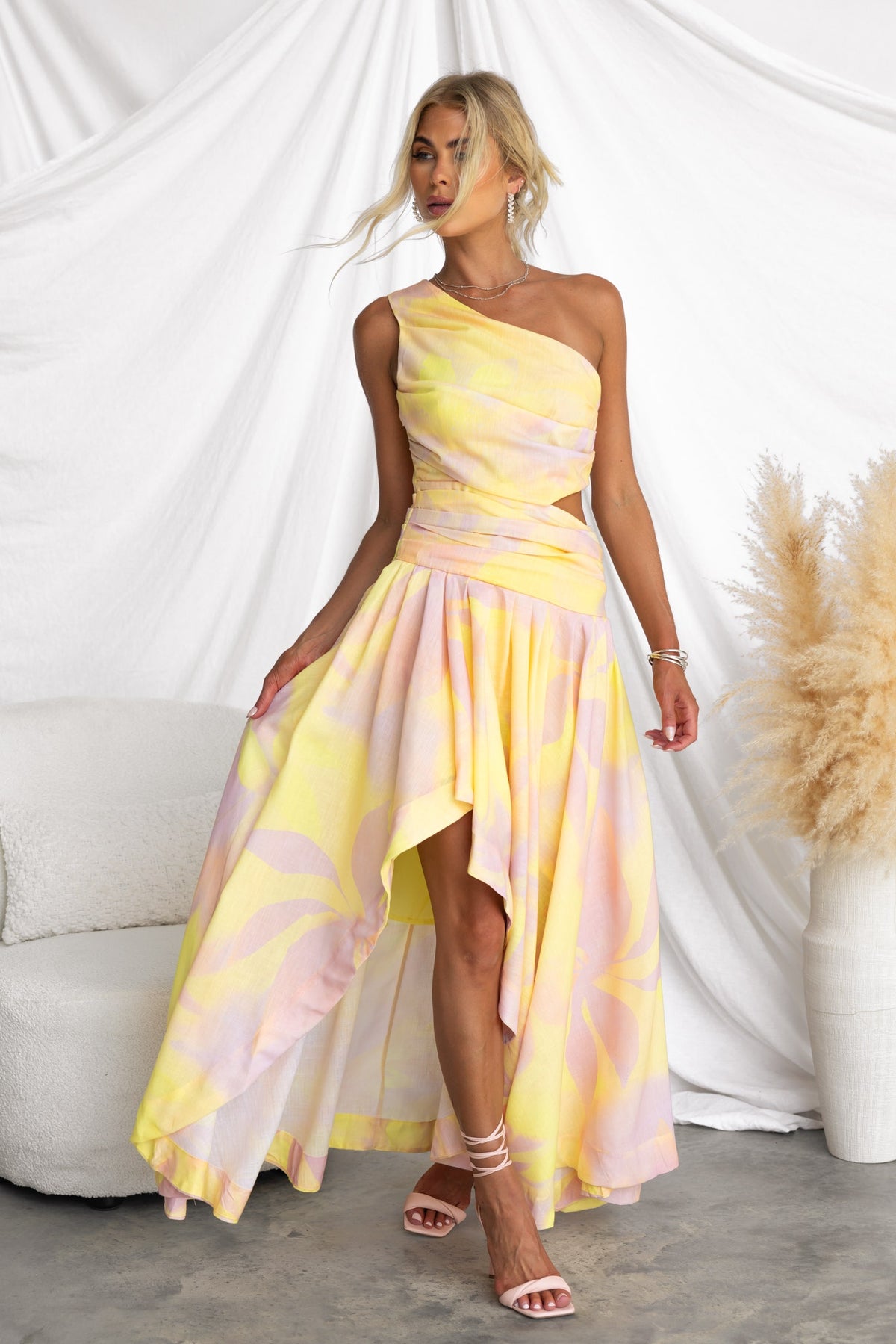 Model wearing a multi-colour Horizons Maxi Dress with one-shoulder neckline and asymmetrical hemline.