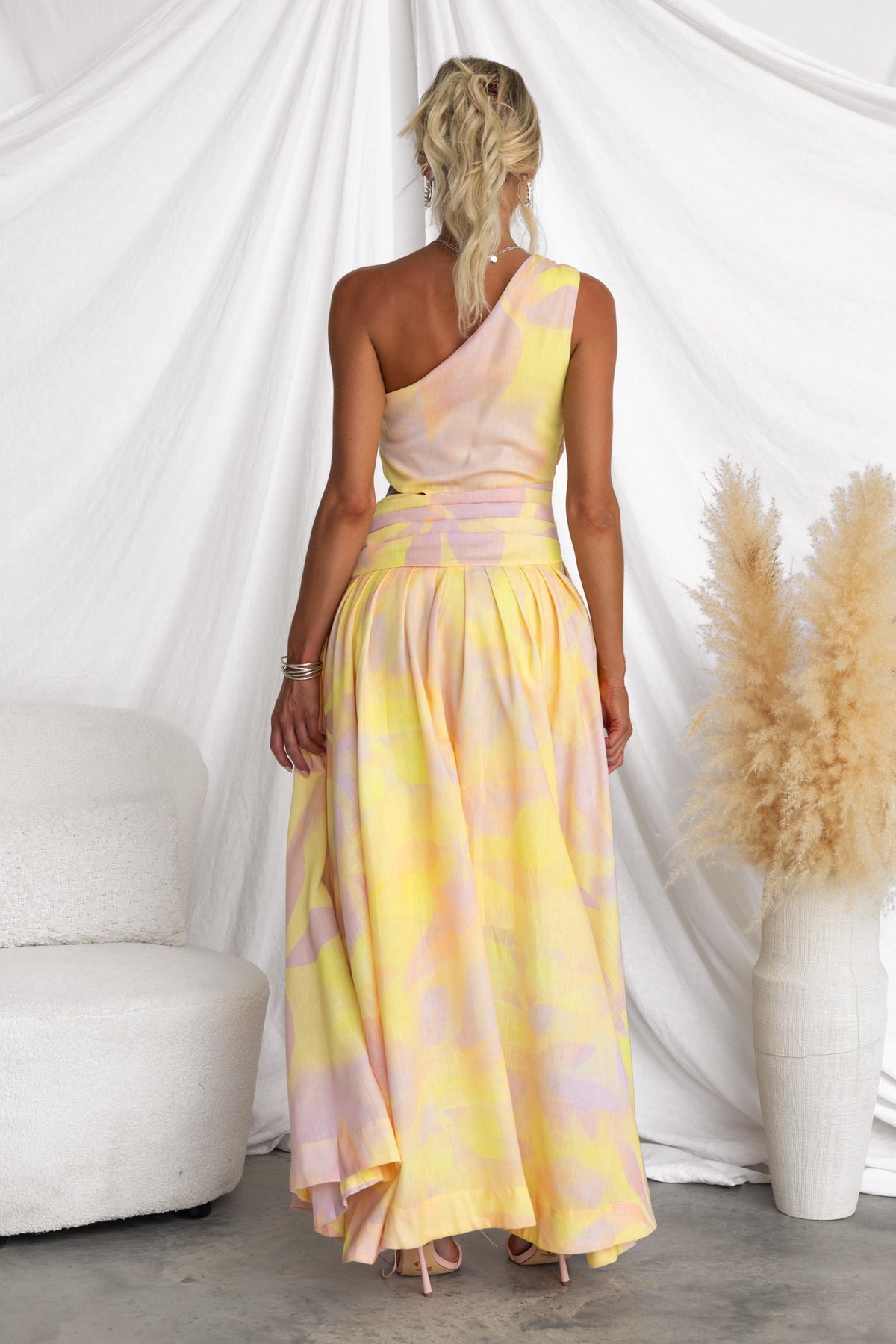 Back view of a multi-colour Horizons Maxi Dress featuring a one-shoulder neckline and asymmetrical hemline.