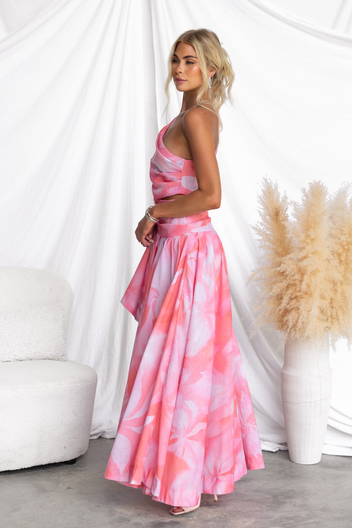 Models the Horizons Maxi Dress featuring a multi-colour design with a one-shoulder neckline and an asymmetrical hemline.