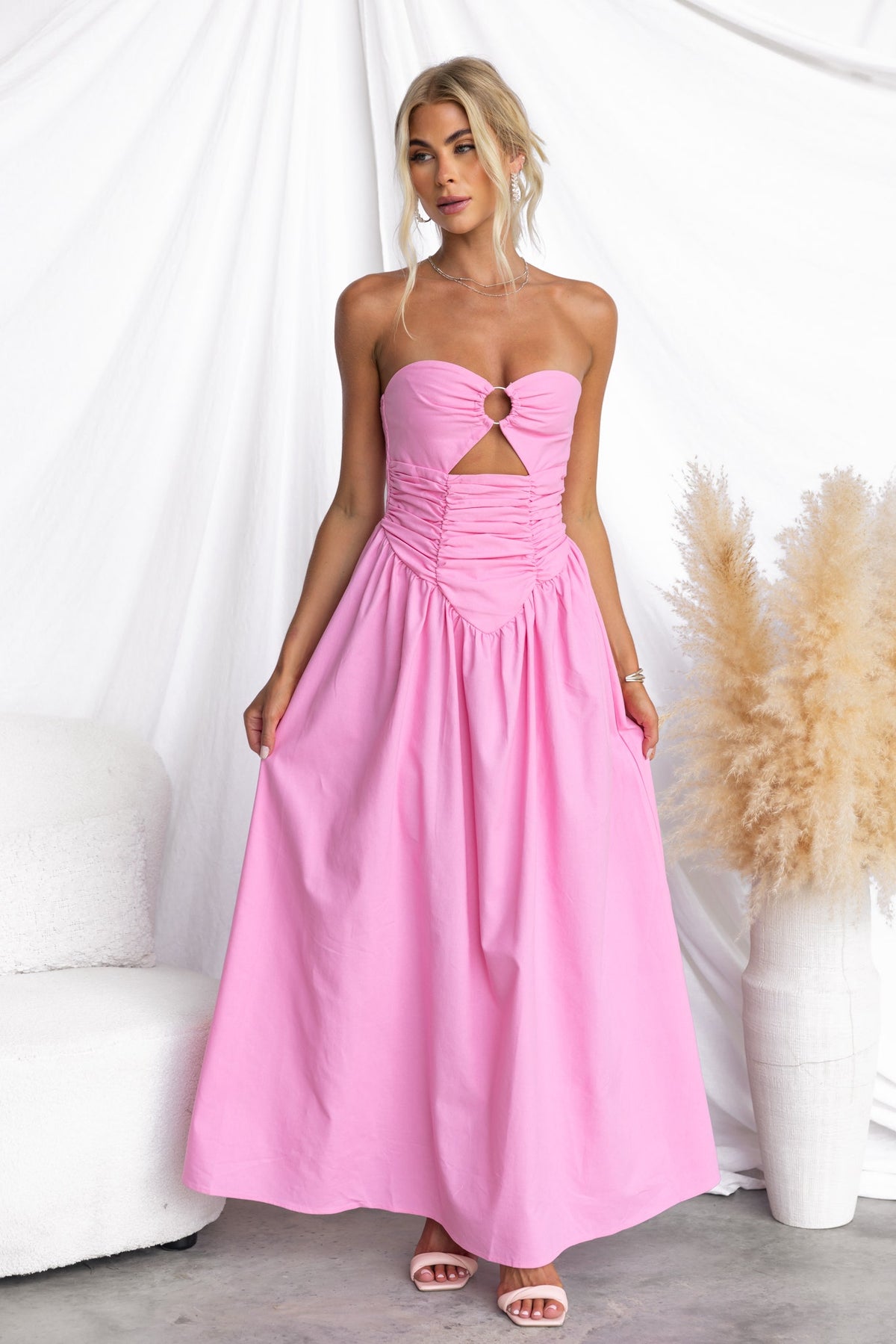 Abelle Maxi Dress in pink featuring a strapless design, ring detail at the bust, and a flattering cut-out under the bust.
