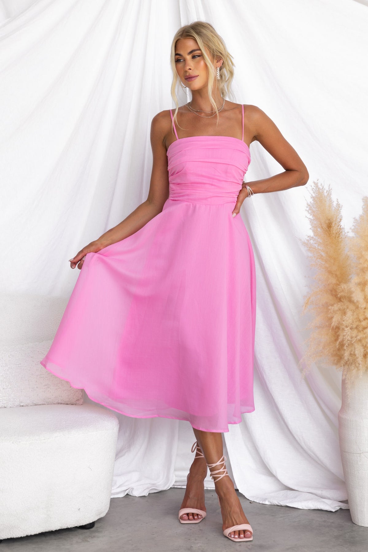 Reilan Midi Dress in pink with adjustable straps and chiffon material, perfect for a stylish summer look.