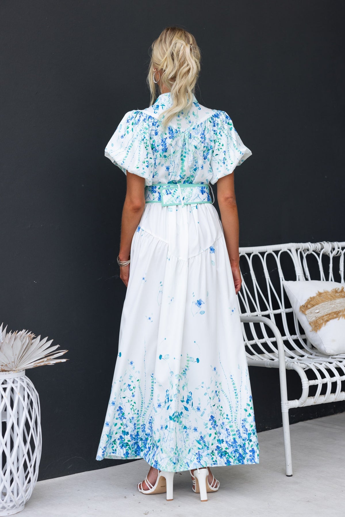 Back view of the Younger Now Maxi Dress featuring a floral print, high neckline, and elastic details.