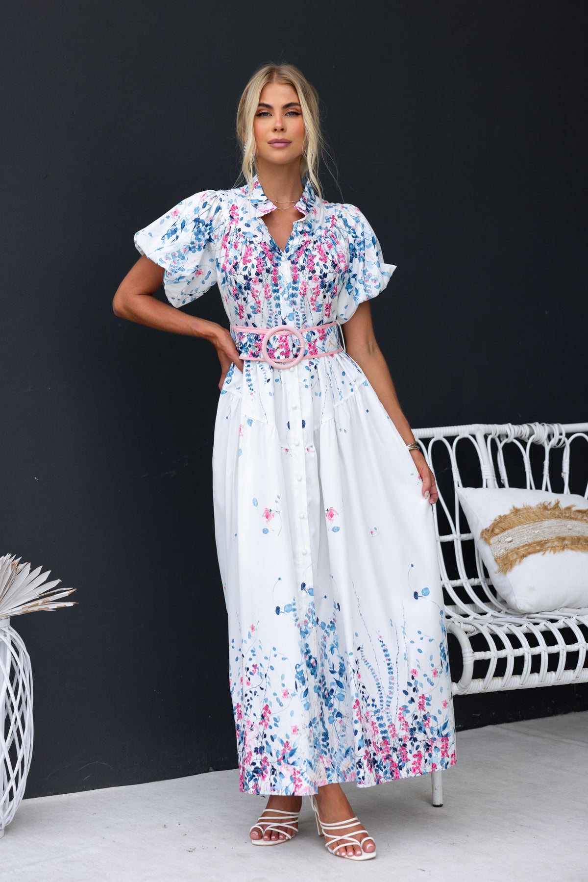 Model wearing Younger Now maxi dress with floral print, high neckline, and removable belt against a dark background.