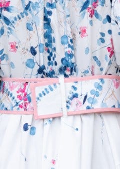 Close-up of the floral print and pink belt of the Younger Now Maxi Dress, showcasing its detailed design.