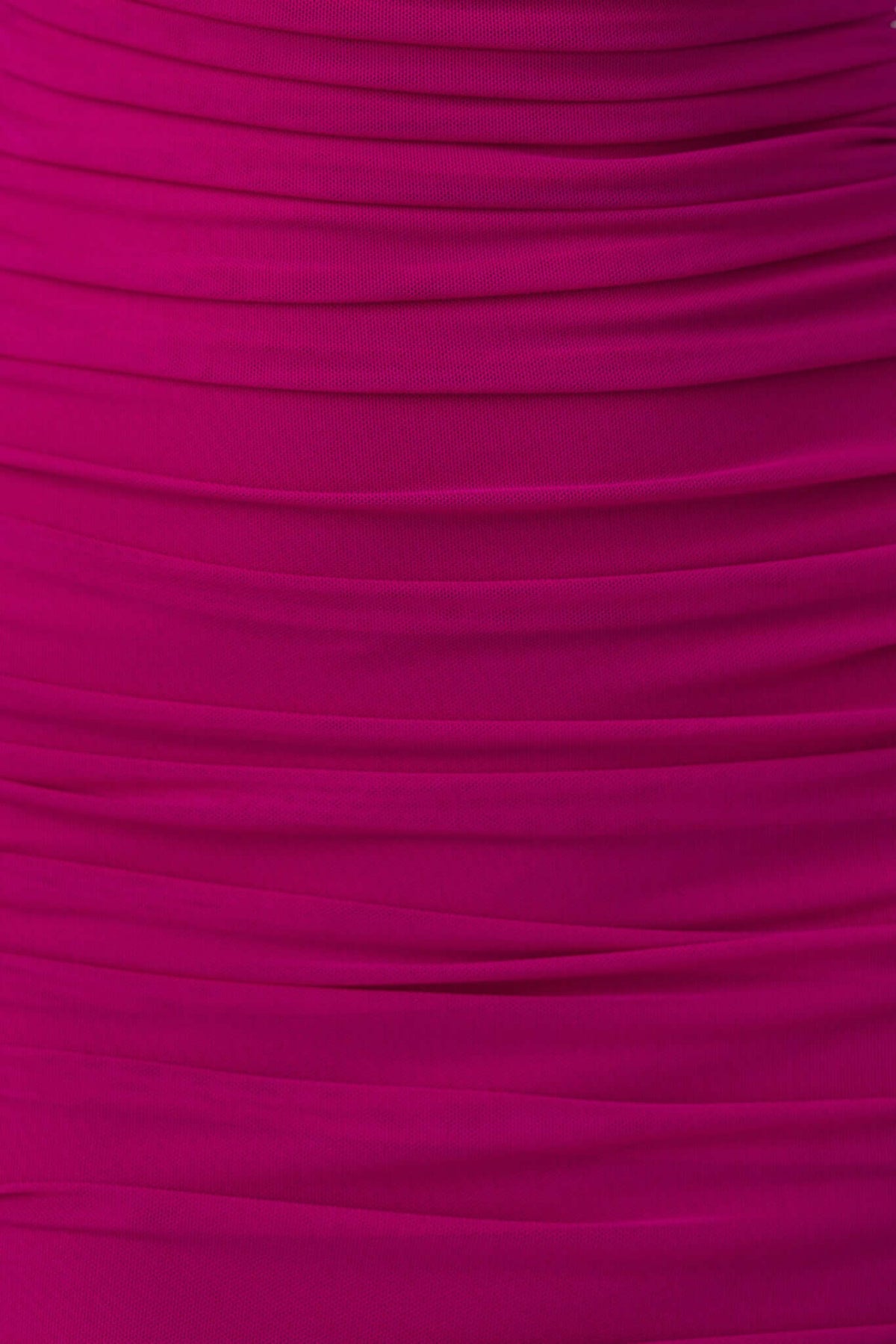Close-up of a ruched fuchsia fabric, showcasing the stretch and texture of the Ledger Midi Dress.