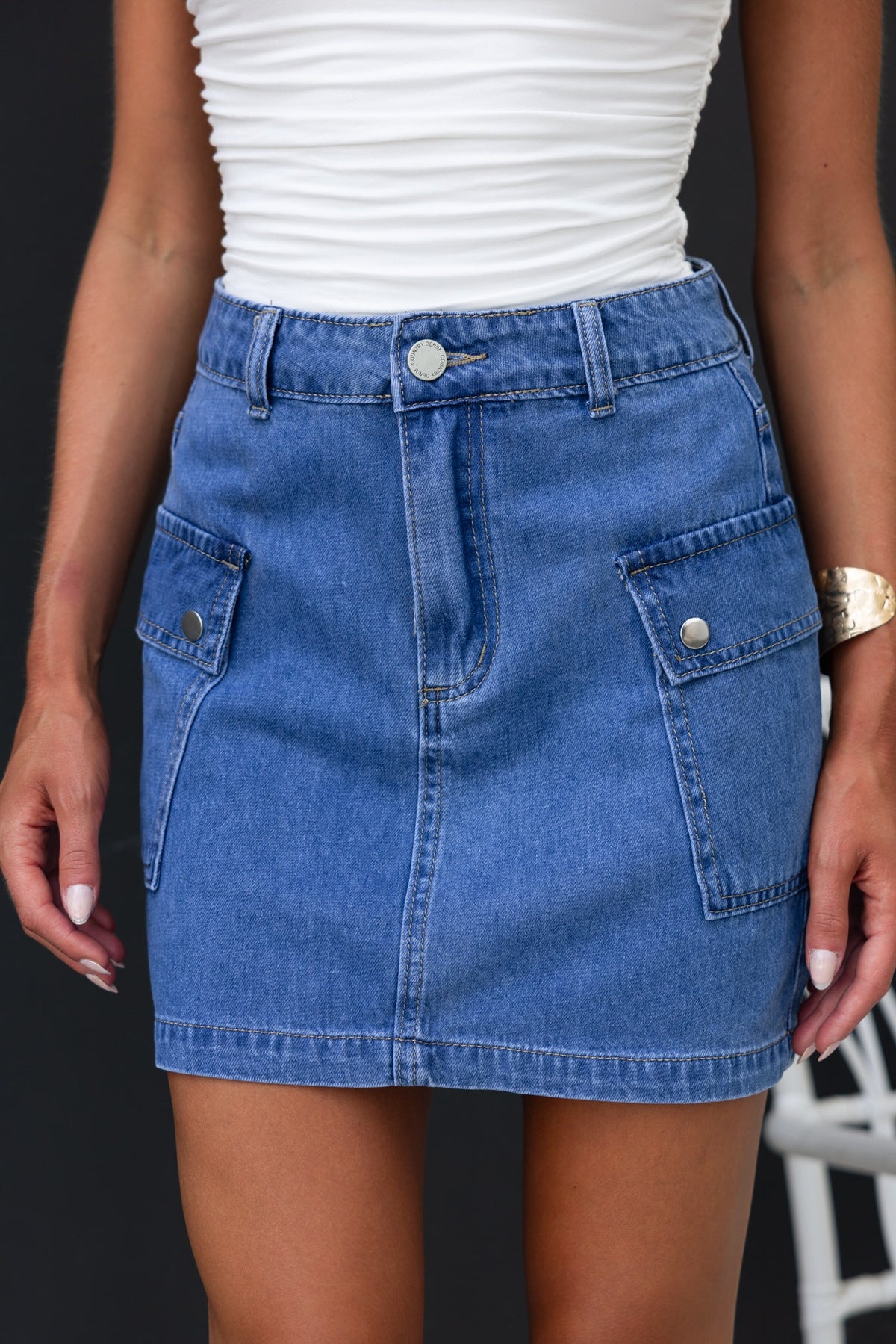 Rubi denim skirt with cargo pockets, styled with a fitted white top, perfect for casual wear.