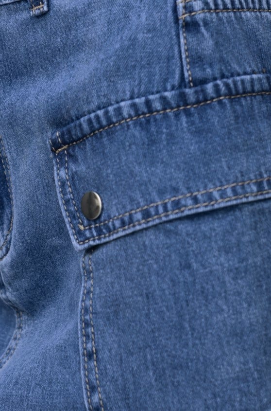 Close-up of cargo style denim skirt with pocket detail, showcasing its cotton fabric and hardware.