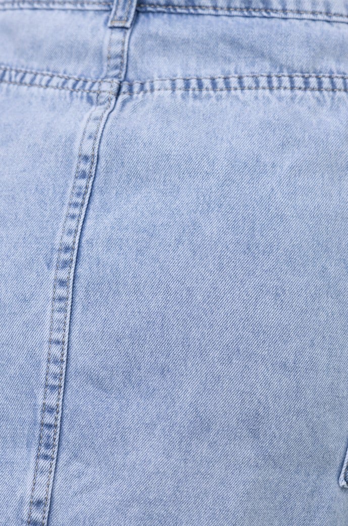 Close-up detail of the Rubi denim skirt showcasing the light blue fabric and stitching.