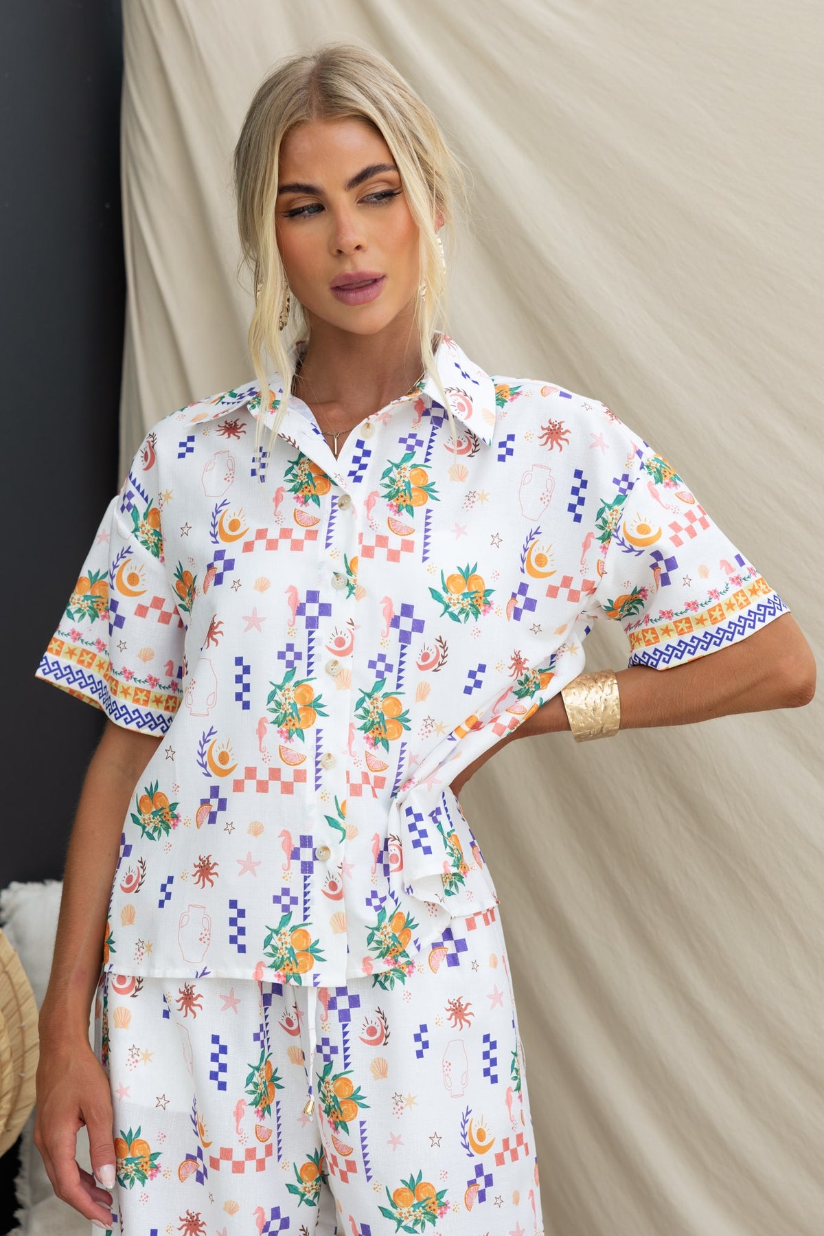Model wearing the Talei Shirt, an abstract print, button-up shirt with a linen look, showcased against a neutral background.