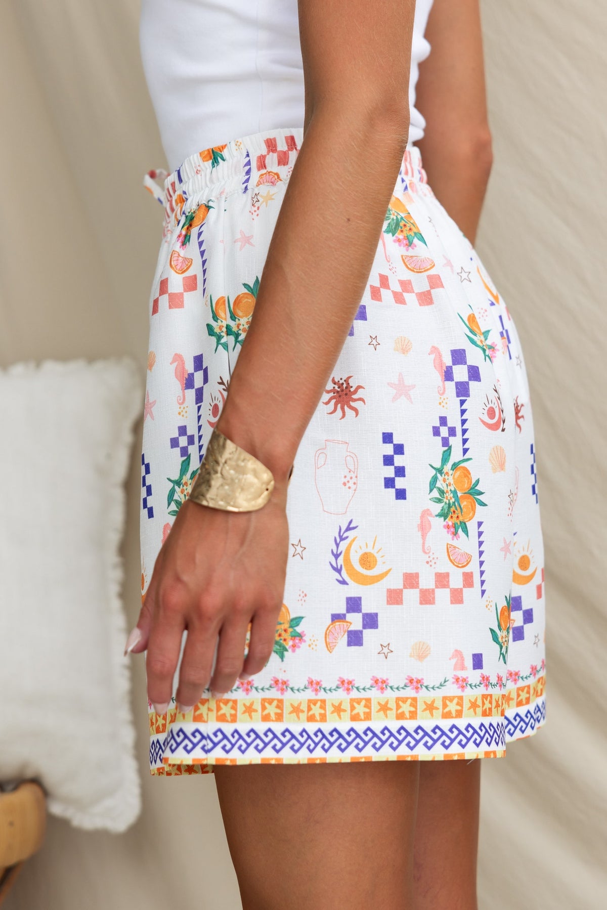 Talei shorts featuring abstract print, mid-high waist fit, and elastic waistband with drawstring.