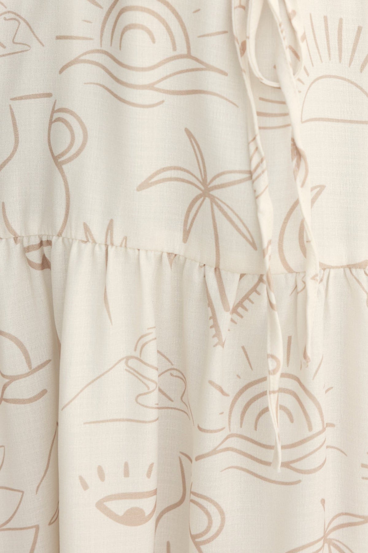 Close-up of the Orwell Midi Dress featuring an abstract sun and palm print in soft beige tones.