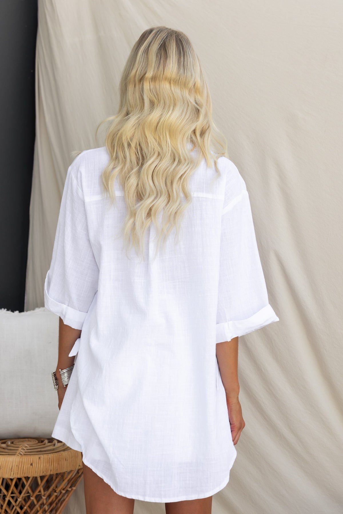 Oceania Shirt in white, featuring rolled cuffs and a relaxed fit, shown from the back against a neutral background.