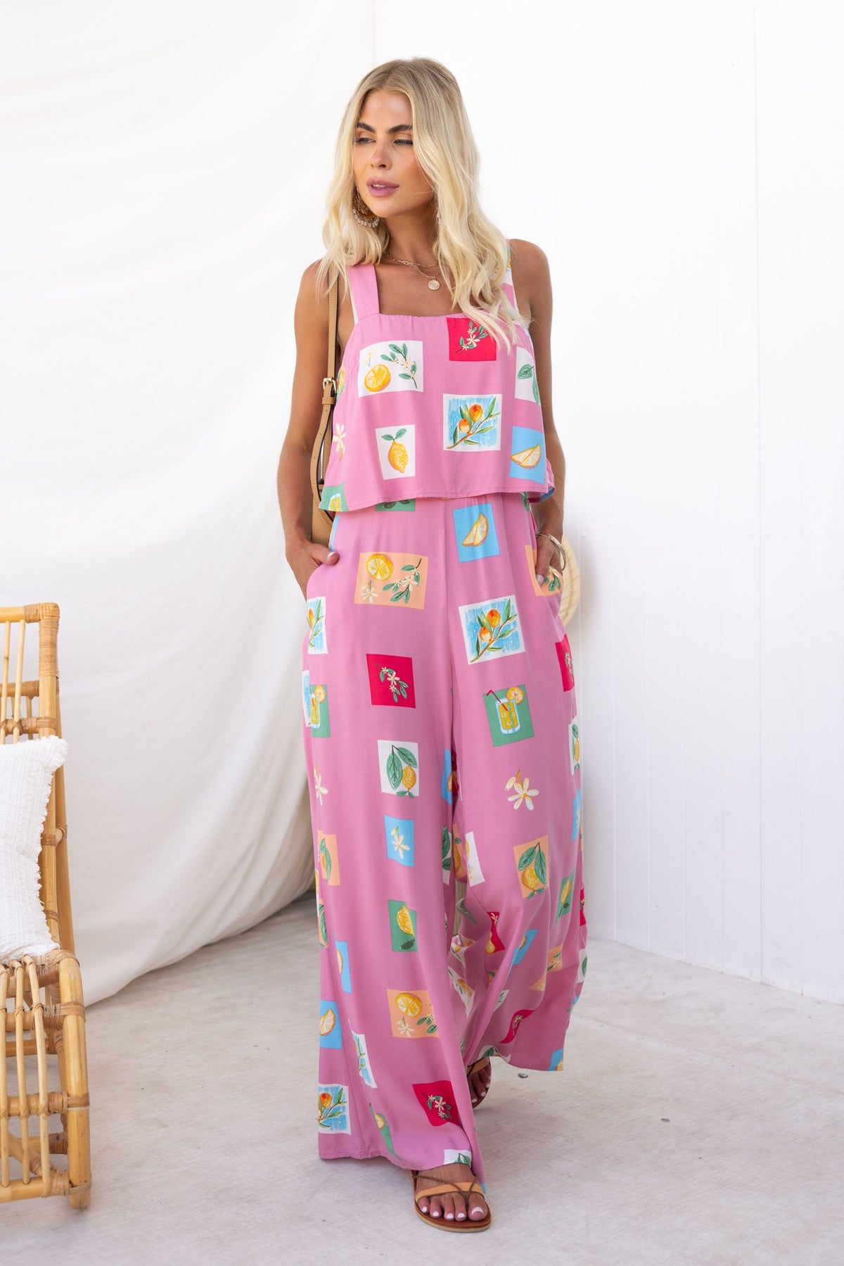Model wearing Verko abstract print jumpsuit in pink, featuring pockets and a stylish design for a comfortable fit.