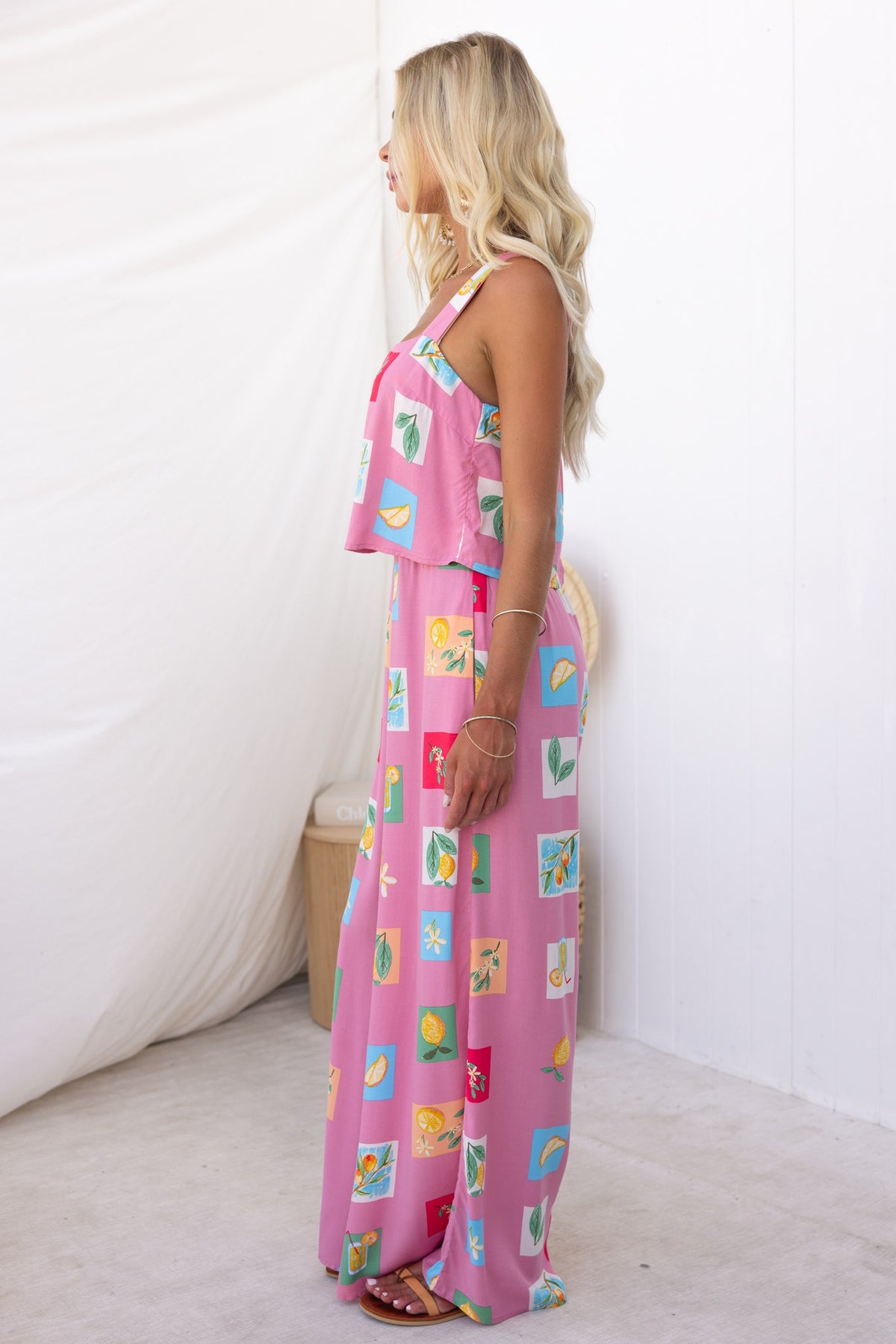 Model wearing Verko Jumpsuit in abstract print, showcasing side view of light, non-stretch fabric and elastic waistband.