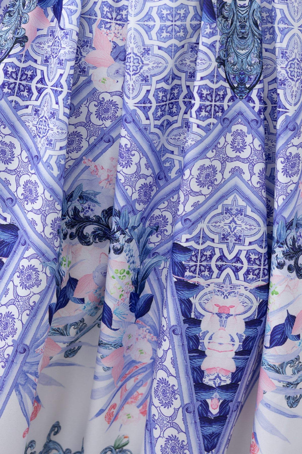 Close-up of the abstract print fabric on the Symi Midi Dress featuring intricate blue and floral designs.