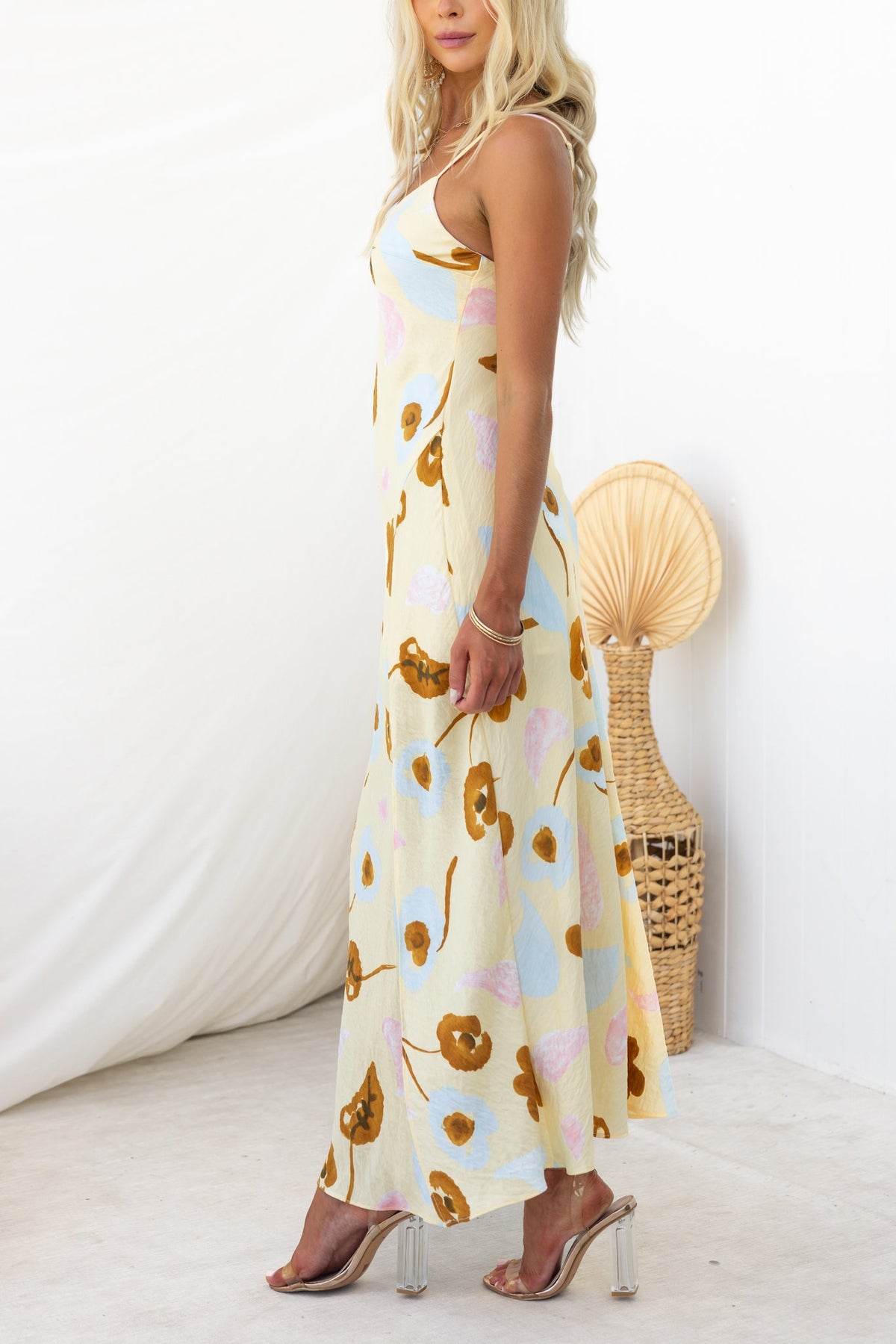 Ellis Maxi Dress in floral print, featuring adjustable straps and a front split, modeled with neutral background.