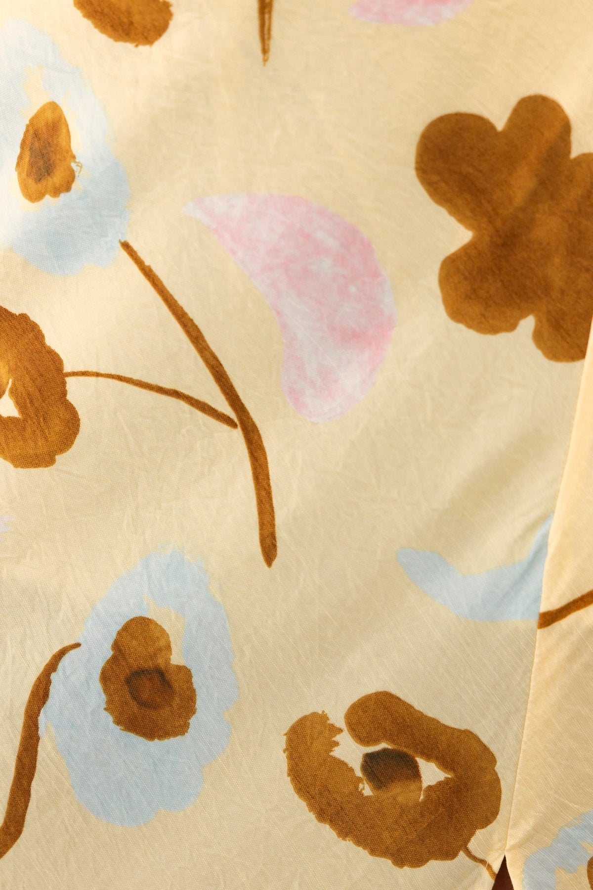 Close-up of floral print fabric in soft pastel shades for Ellis Maxi Dress, featuring a textured design.