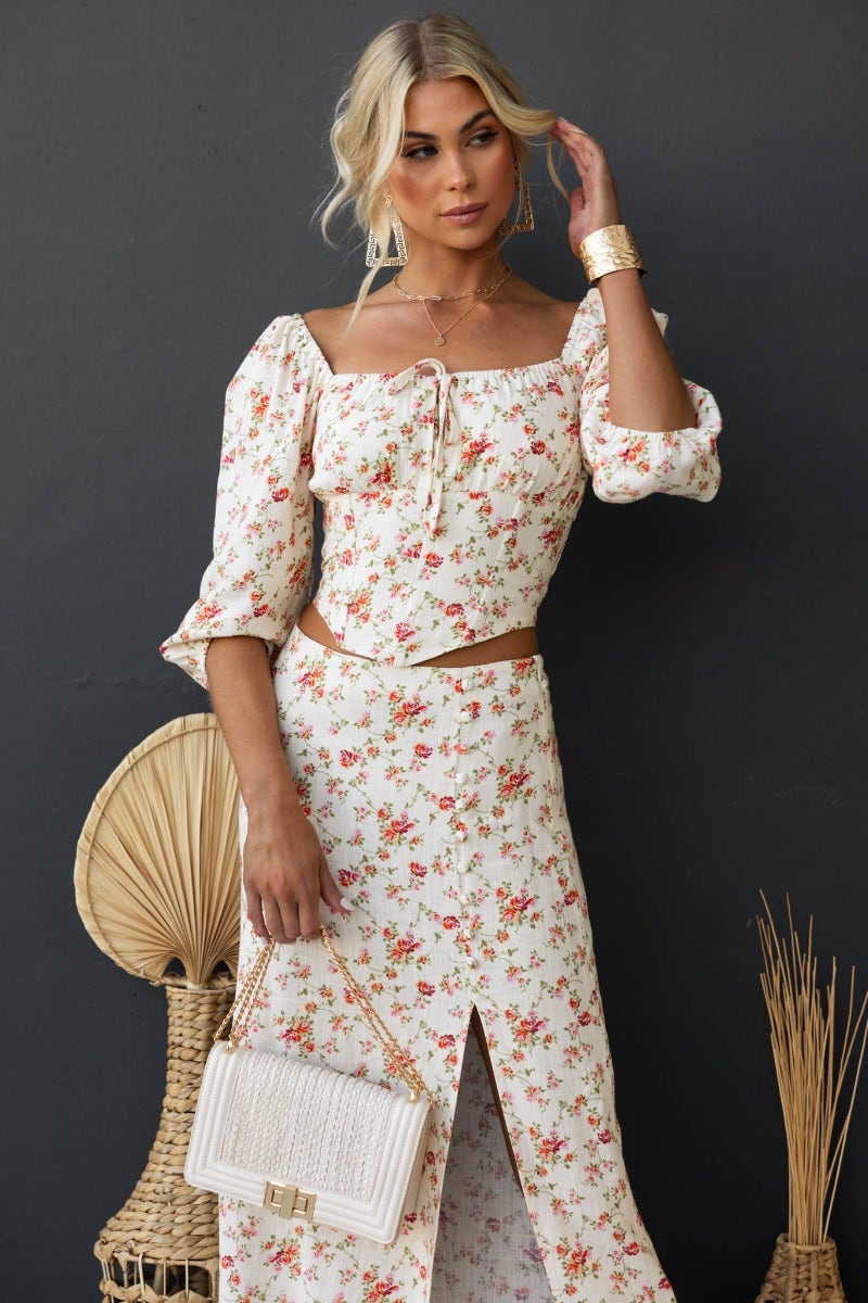 Model wearing Rubie Top, a floral linen blend with tie detail, paired with a matching skirt for a stylish summer look.