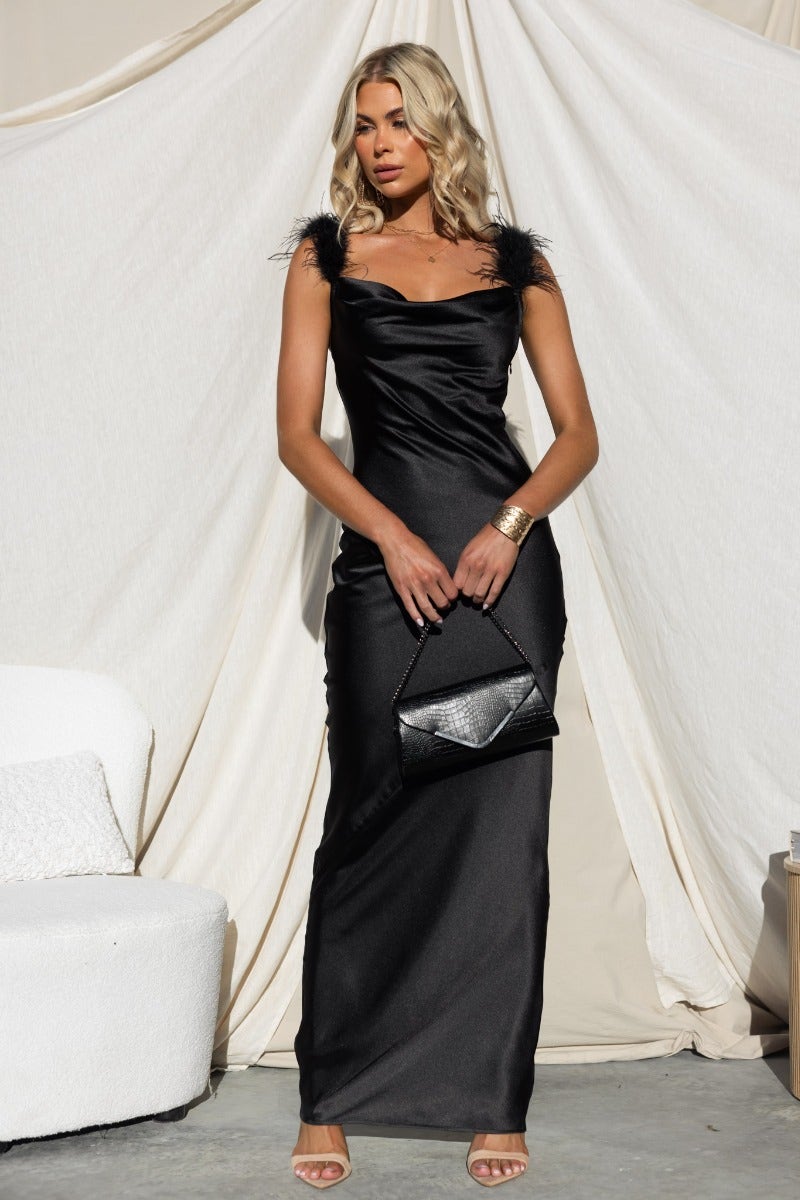 Trixie Maxi Dress in black satin with adjustable straps, feather details, cowl neckline, and side zip.