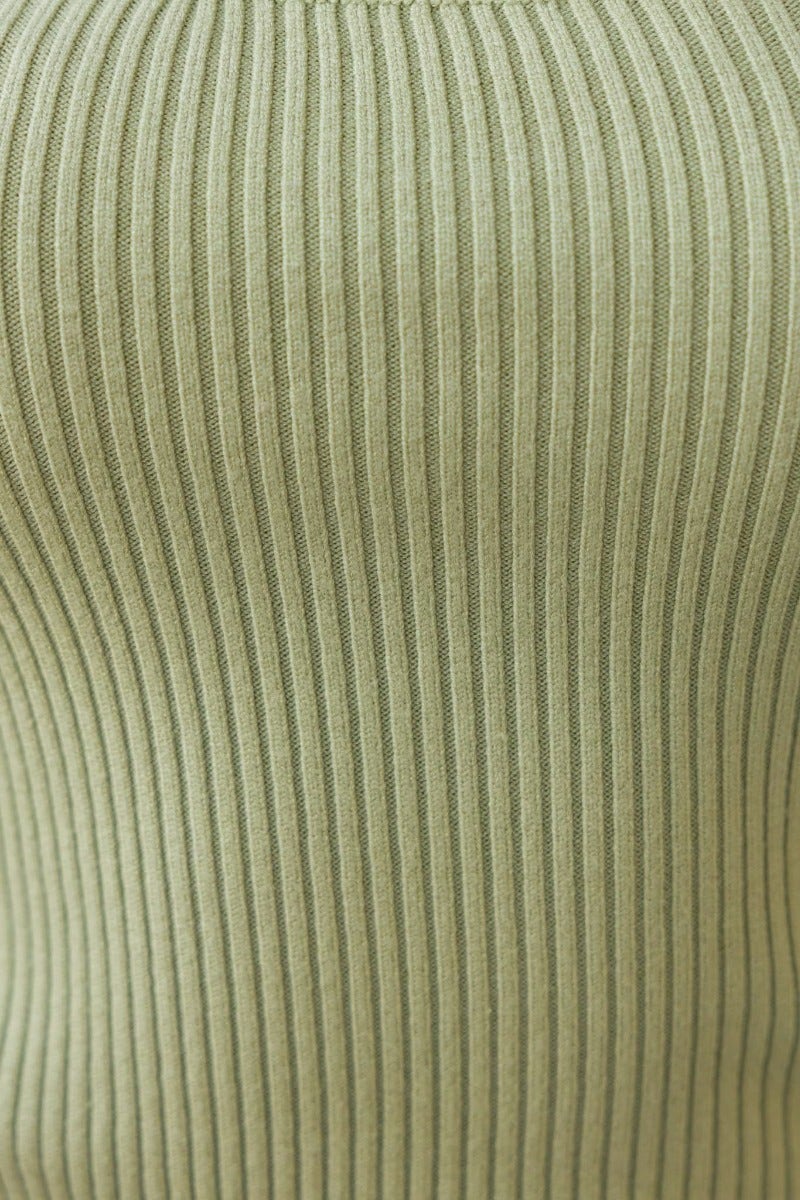 Close-up of ribbed knit material in olive green, showcasing the texture of the Daia Top.