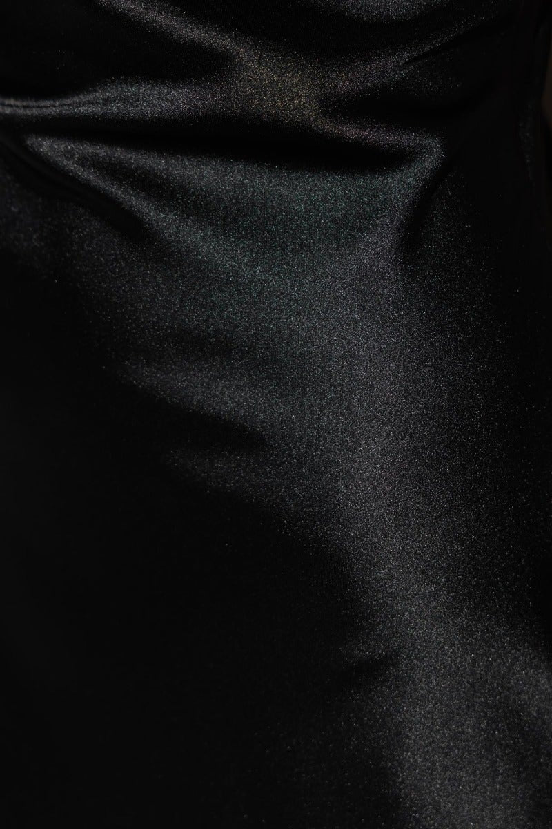 Close-up of black satin fabric, highlighting its smooth texture and sheen of the Trixie Maxi Dress.
