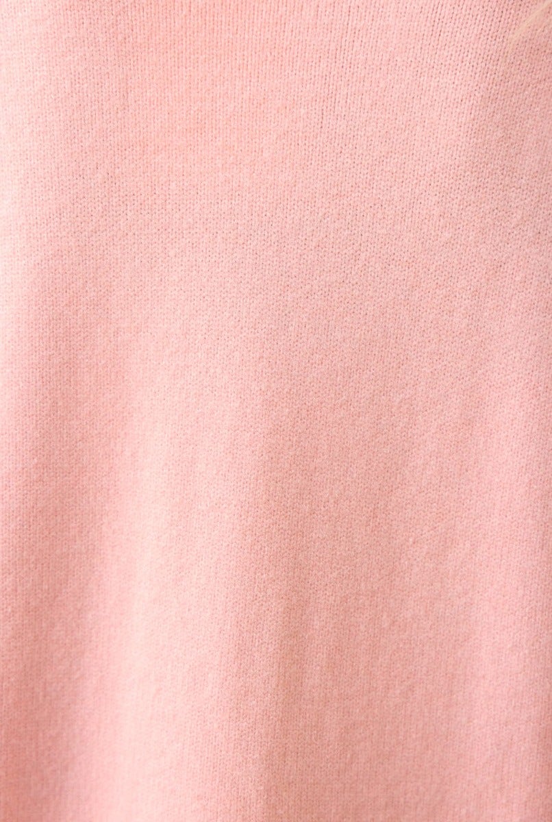 Close-up of soft ribbed knit fabric in light pink color, highlighting the texture of the Hailey Cardigan.