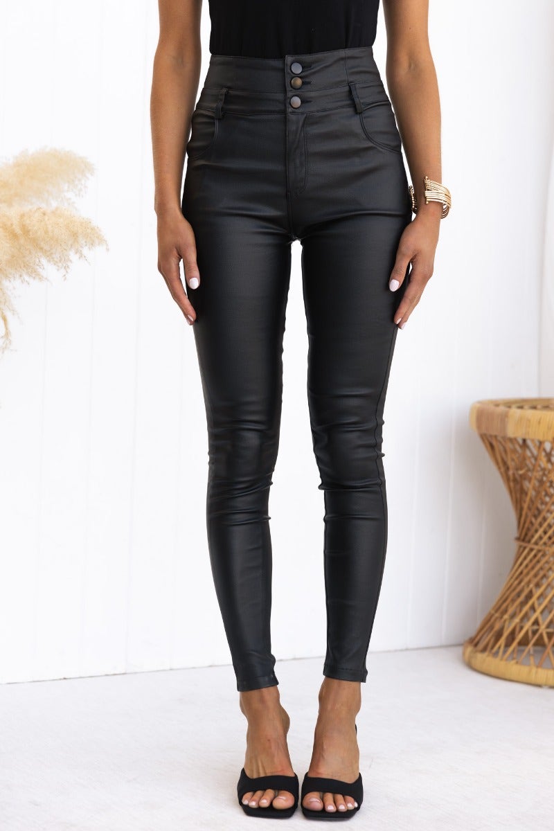 Leni Pants: Black faux leather mid-high waist skinny fit with pockets, model wearing size 6/XS