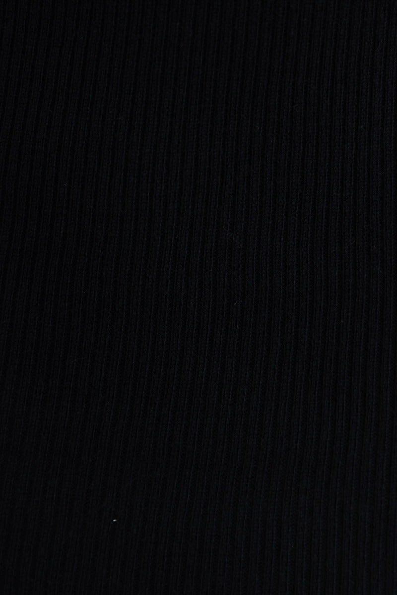 Close-up of black ribbed fabric texture, perfect for a stylish and comfortable maxi dress.