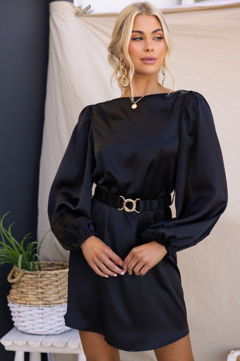 Stylish black satin Charli dress with elastic cuffs, removable belt, and a standard fit, showcased by a model.
