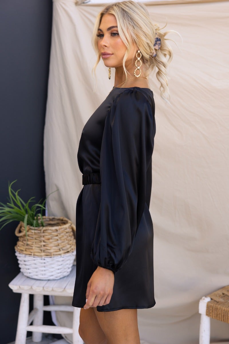 Elegant black satin Charli dress with elastic cuffs and removable belt, perfect for a stylish occasion.
