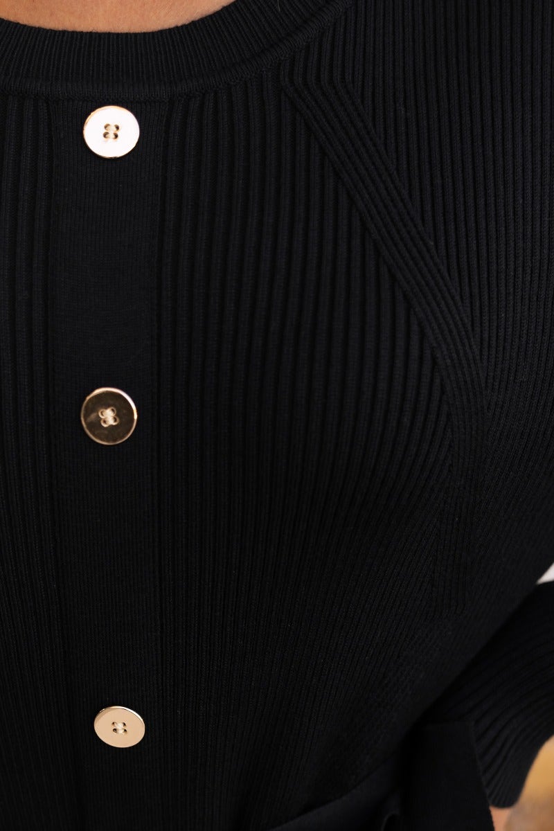 Close-up of black ribbed fabric with faux button-up details on Nicola Maxi Dress, showcasing its style and texture.