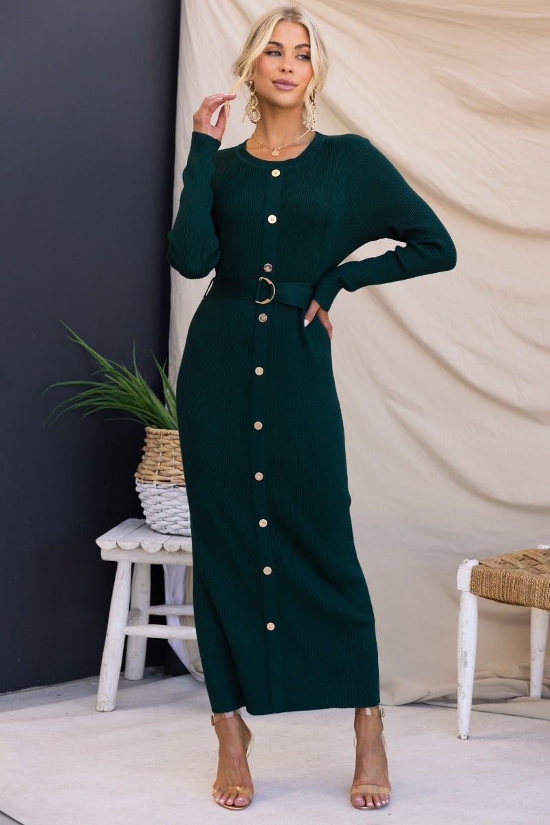 Model wearing a dark green ribbed Nicola Maxi Dress with faux button-up front and removable belt.