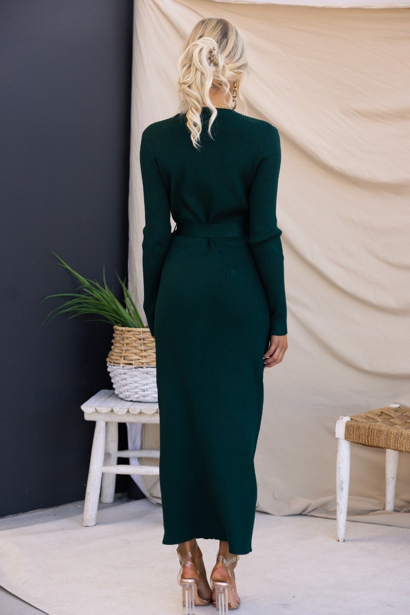Back view of dark green ribbed Nicola maxi dress with removable fabric belt, showcasing its elegant design.