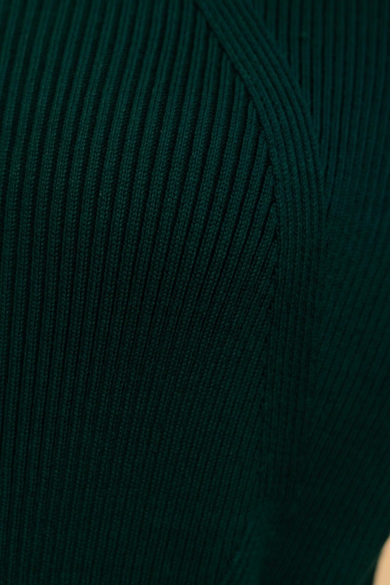 Close-up of dark green ribbed fabric showcasing texture of Nicola Maxi Dress, made from stretchy cotton-polyester blend.