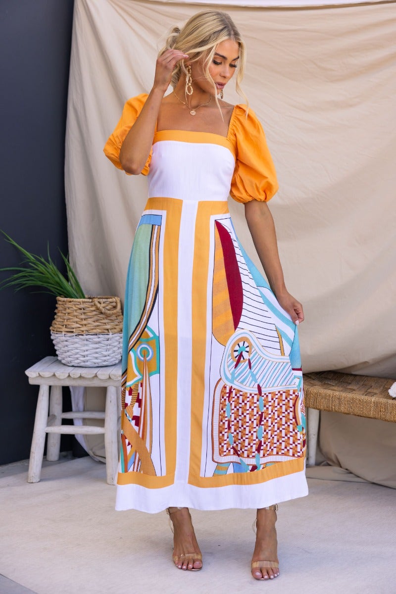 Multi-colour Turner Maxi Dress with square neckline and elastic sleeves, featuring vibrant patterns and a side zip.