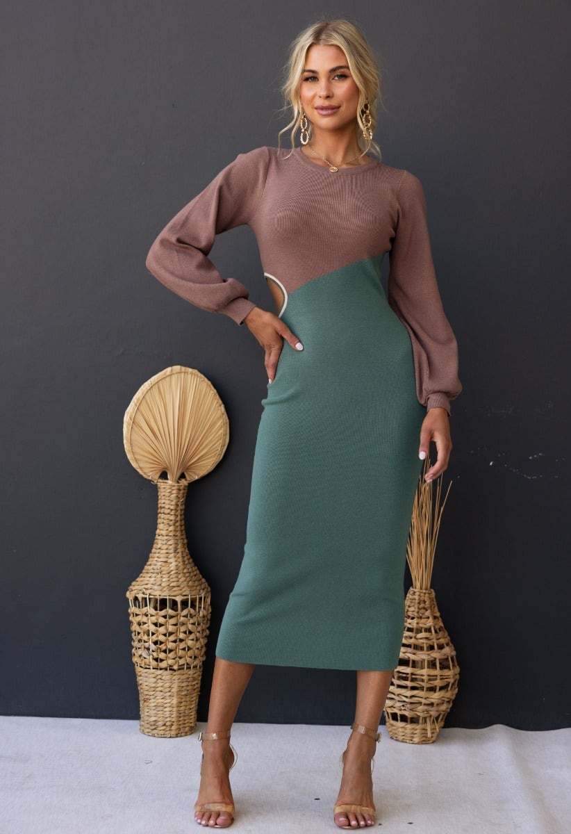 Torez Midi Dress in ribbed material featuring bishop sleeves and a cut-out waist, styled with woven decor.