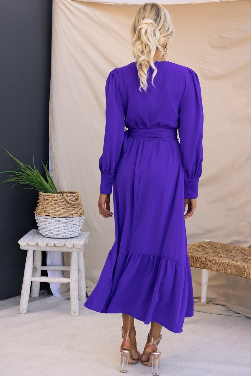 Alizzie Midi Dress in purple, featuring a V-neckline, elastic waistband, and removable belt, styled from the back.