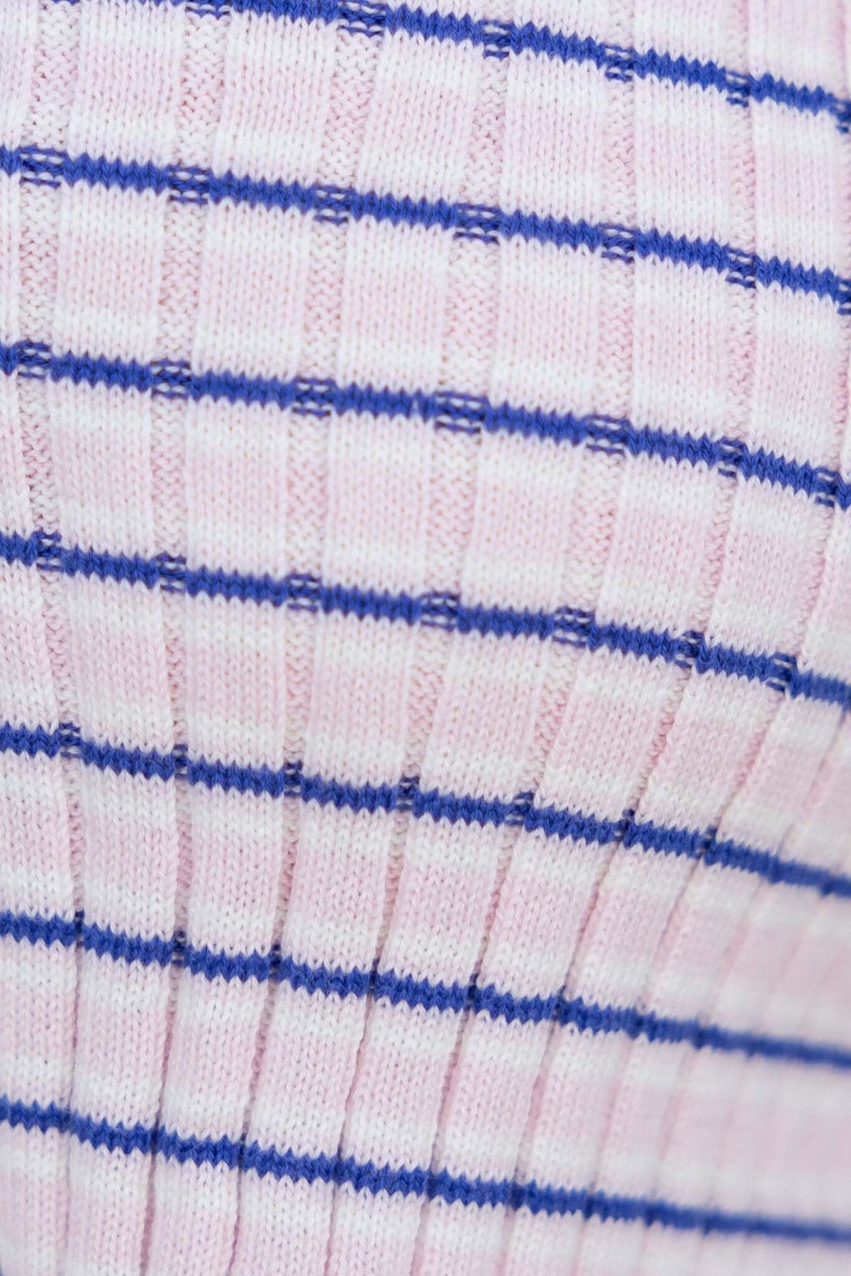 Close-up of ribbed knit fabric in pink with blue stripes, showcasing texture and stretch for the Evan Top.