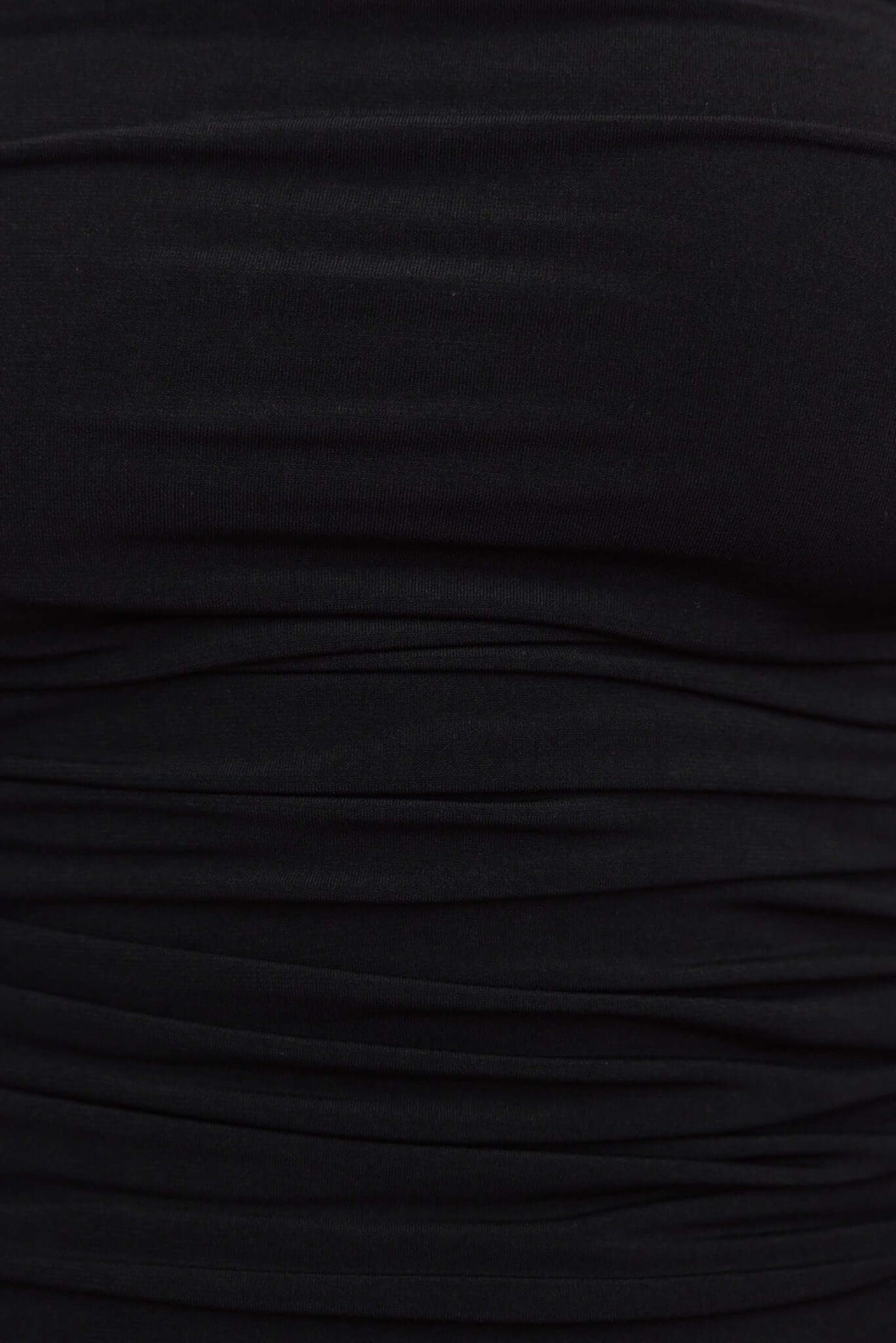 Close-up of Ivita Top in black, featuring a textured ruched fabric design, showcasing its stretch material.