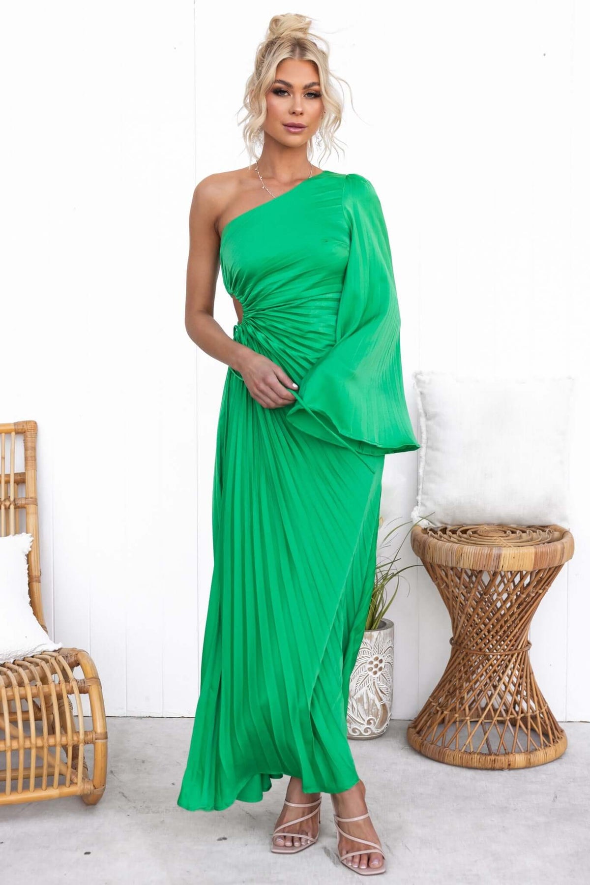 Regal maxi dress in vibrant green, featuring pleats, one-shoulder style, and a cut-out waist with drawstring tie.