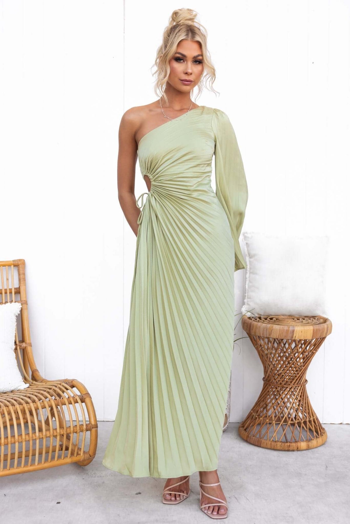Regal maxi dress featuring pleats, one-shoulder style, and cut-out waist in a soft green color.