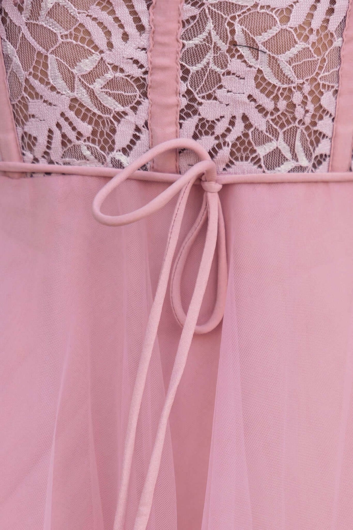 Close-up of Wash Away Maxi Dress showing pink tulle fabric, lace detail, and removable fabric tie.