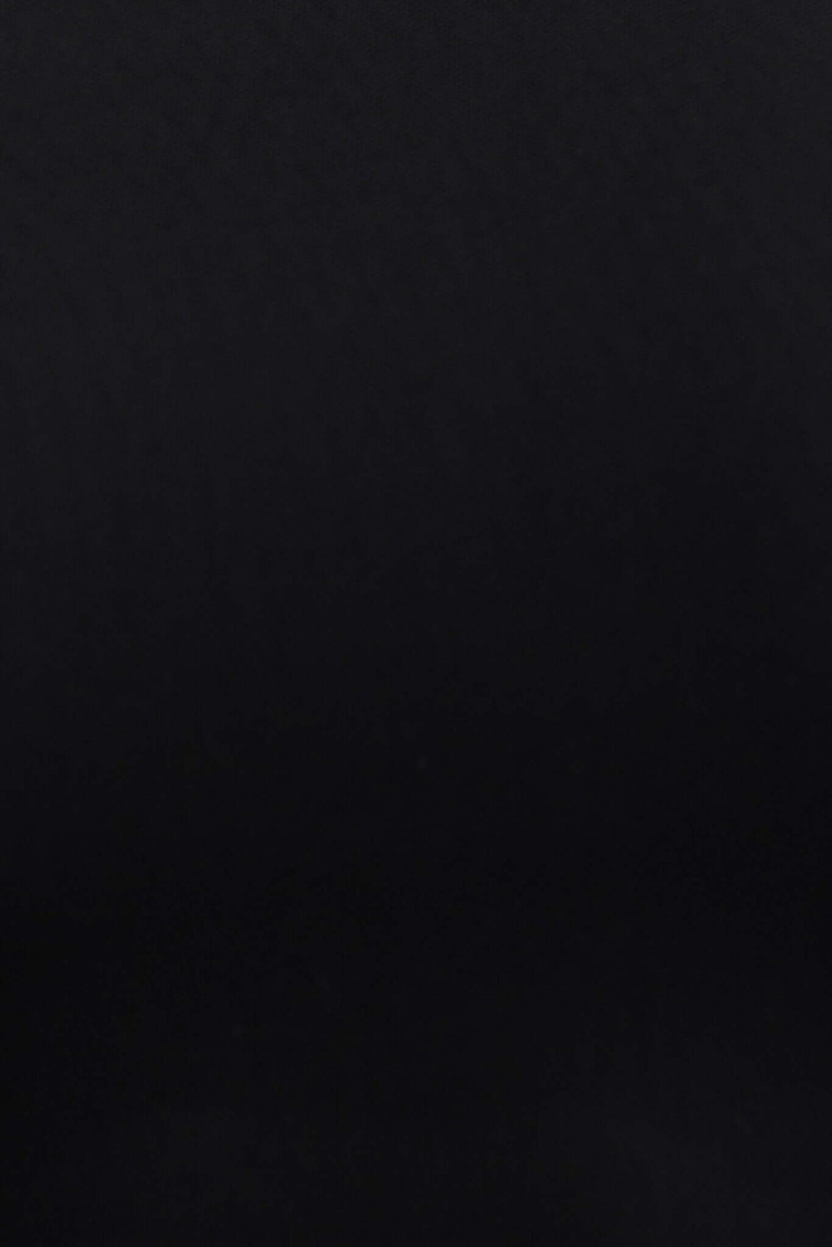 Close-up of the fabric texture of the Aletta Midi Dress in black, showcasing its stretch and soft material.