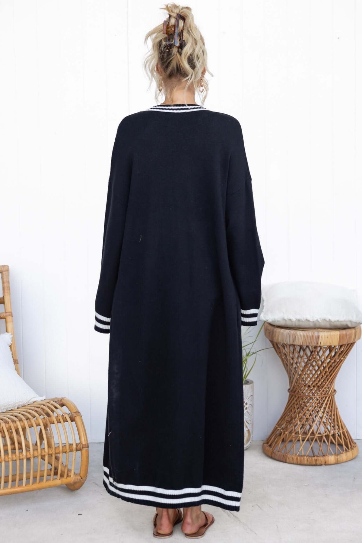 Back view of Gritti Cardigan in black, featuring longline fit and striped cuffs, perfect for layering.