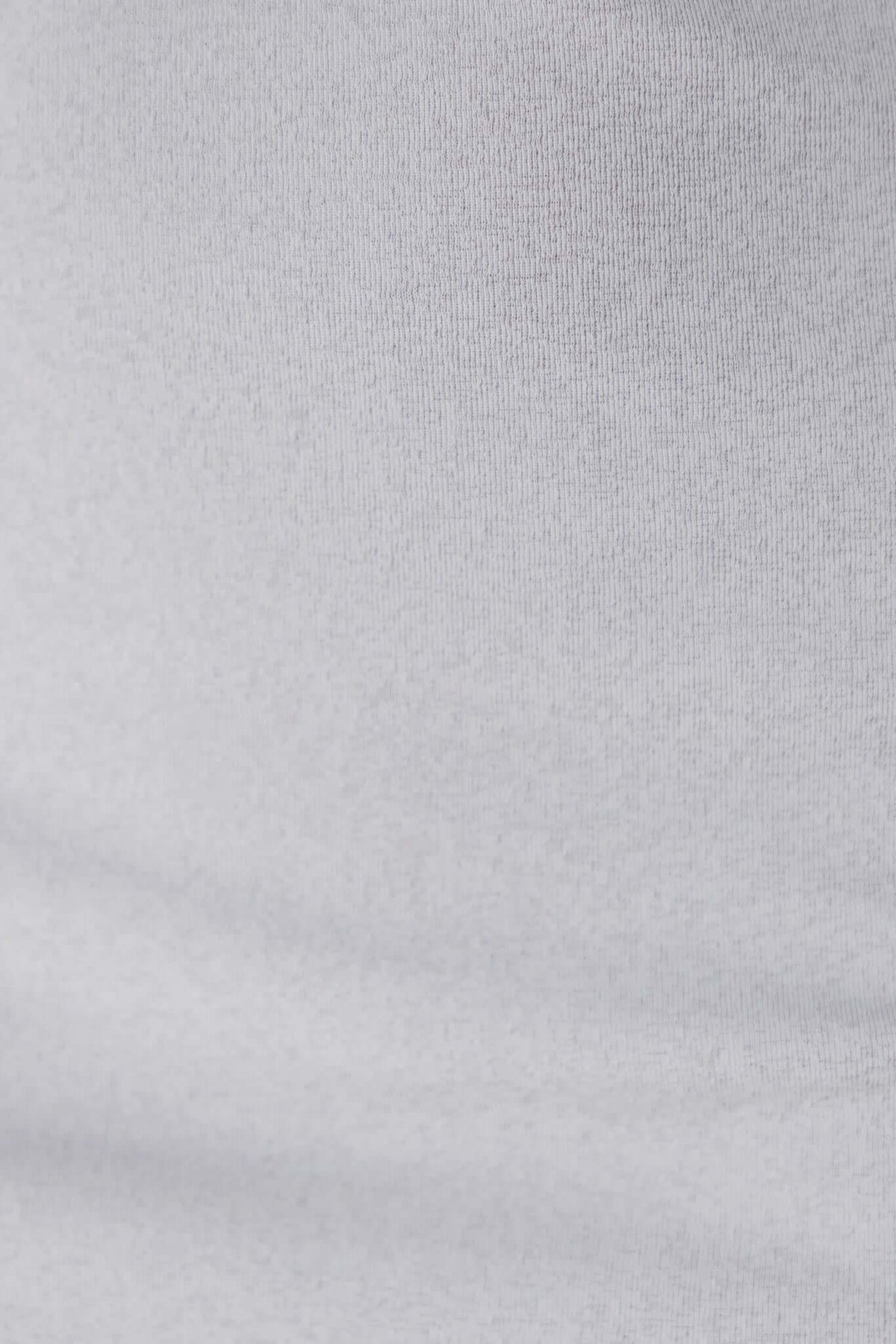 Close-up of the Idol Top fabric texture, showcasing the soft, stretchy 100% polyester material in light gray.