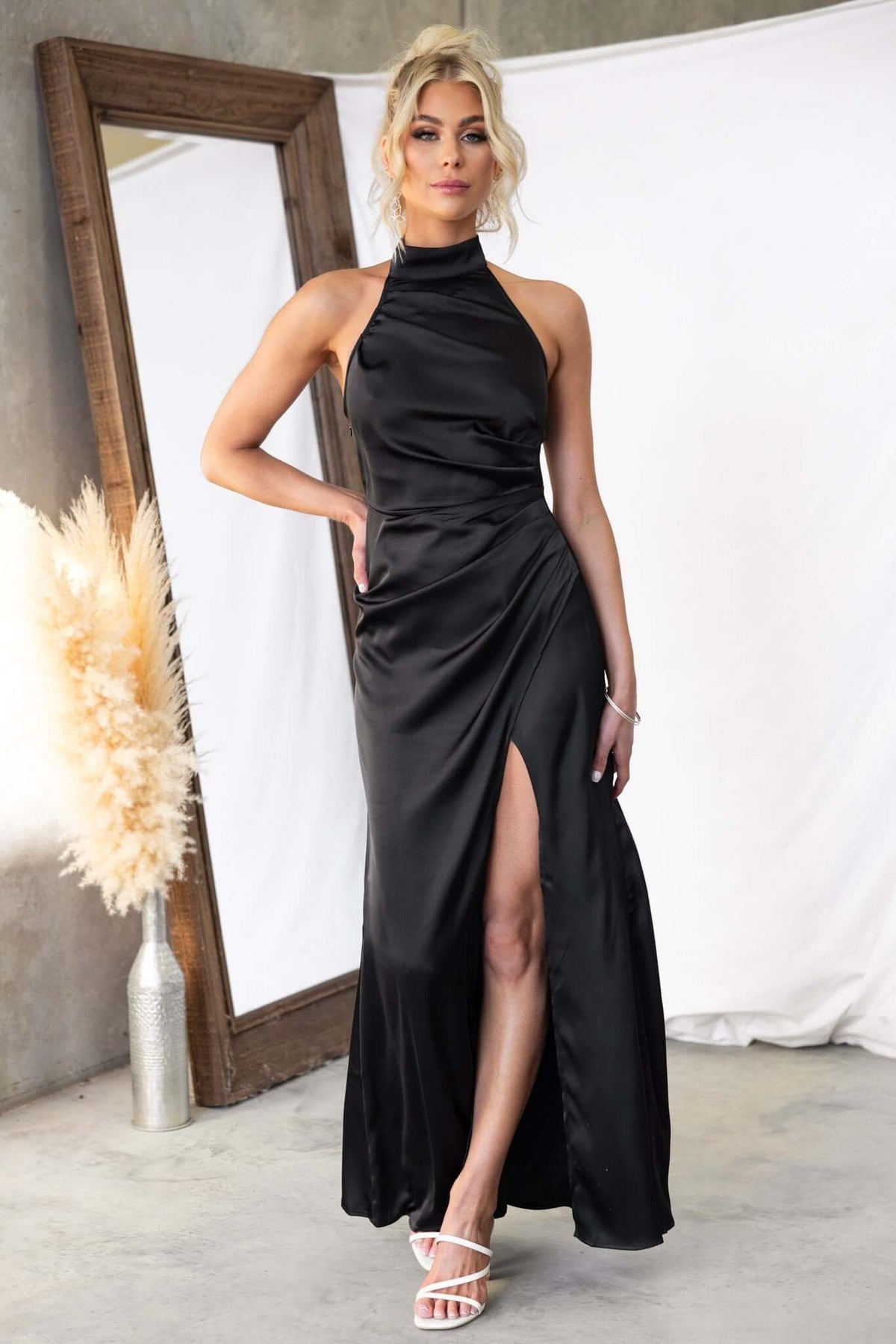 Elegant black Levona maxi dress with high neckline and side slit, perfect for formal occasions.
