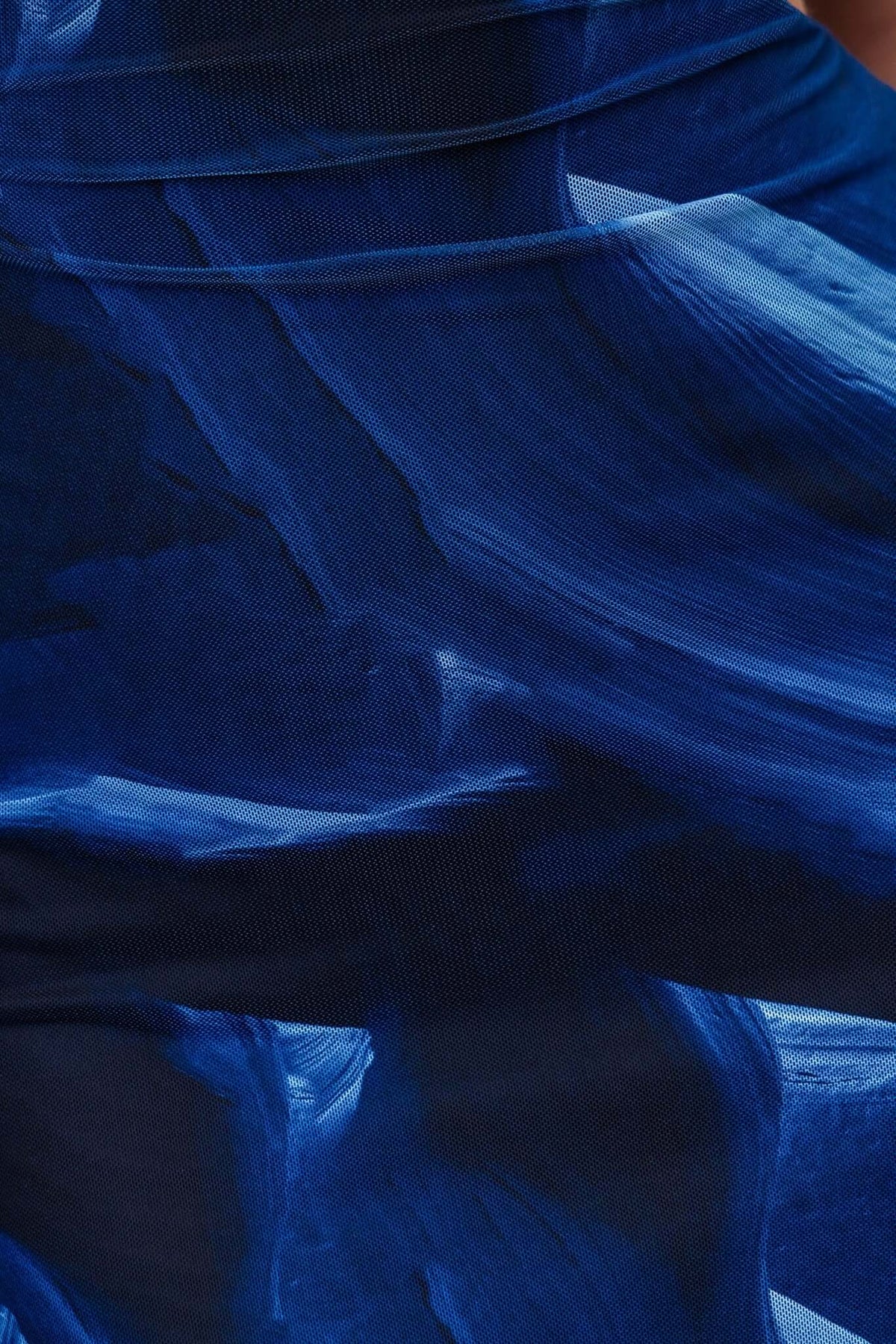 Close-up of blue brushstroke pattern on Kalena Maxi Dress, highlighting its flowing fabric and vibrant design.