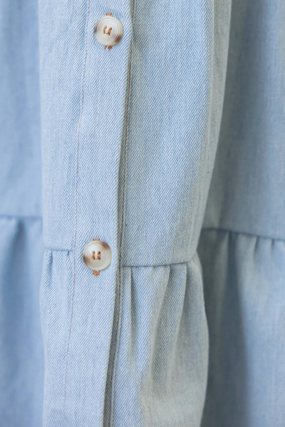 Close-up of Jessy Denim Dress showing button details and soft fabric texture.