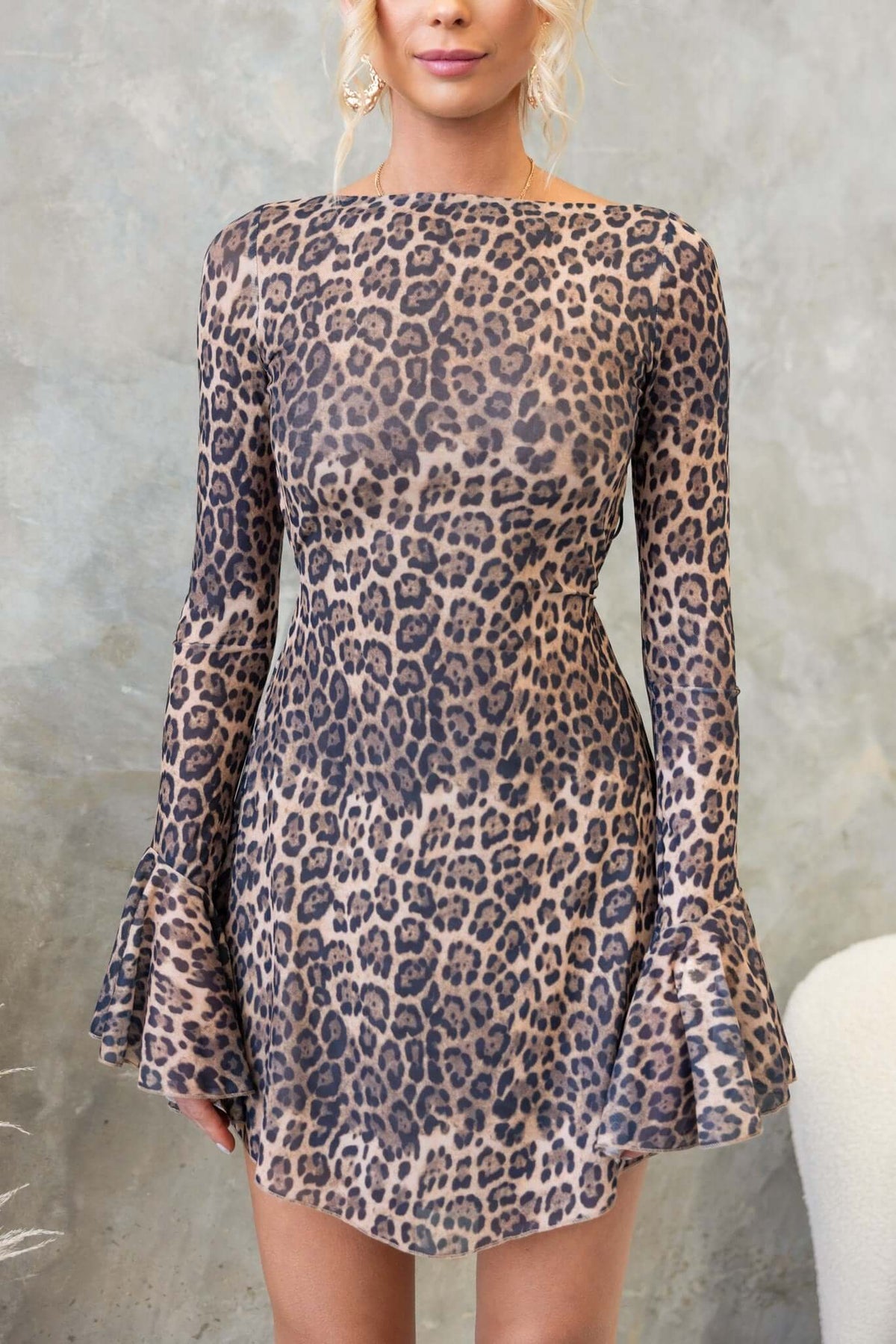 Catiana Dress featuring a leopard print design, boat neckline, and bell sleeves, perfect for stylish occasions.